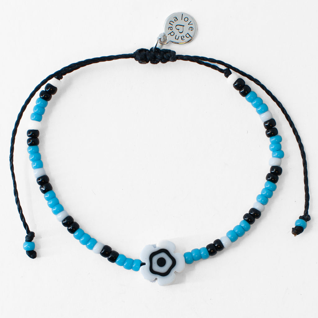 White Millefiori Flower in Turquoise and Black Beaded String